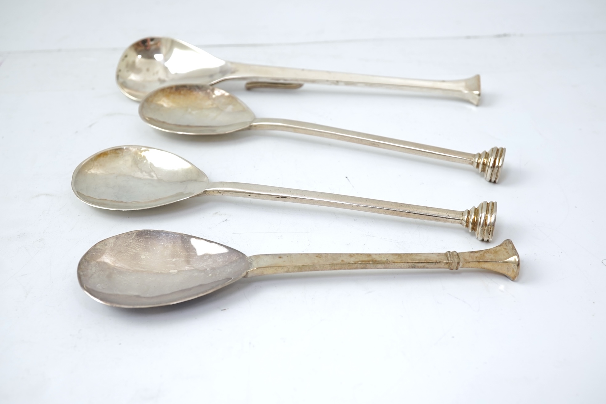 A pair of Elizabeth II silver 'seal top' spoons by The Guild of Handicrafts, London, 1990, 16cm, together with a similar later spoon, London, 2008 and a similar preserve spoon, London, 2003, two with boxes.
